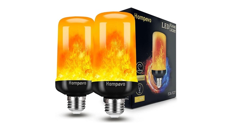 A pair of decorative lightbulbs next to their packaging