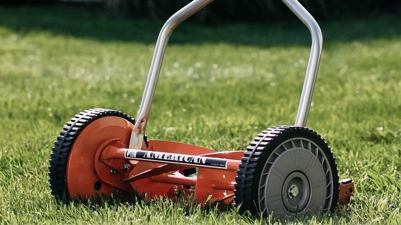 Orange American Lawn Mower on a grassy yard