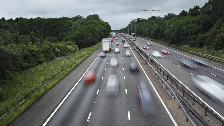 Cars rushing down a freeway.
