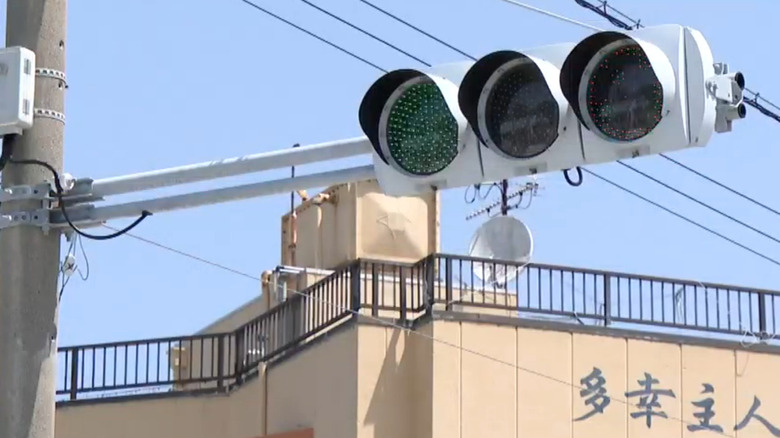 A green traffic light hanging in Himakajima, Japan.