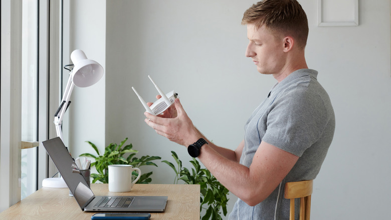 Man looking at router