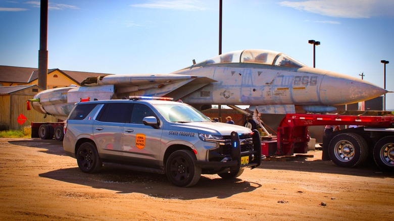 A T-14 Tomcat loaded onto a large trailer with a State Trooper parked in front