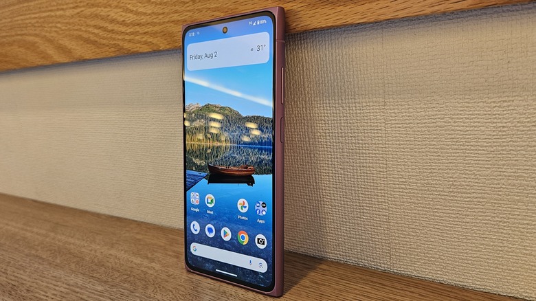 HMD Skyline showing its right side in neon pink while resting on a wooden shelf.