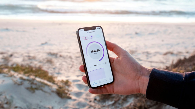 phone on beach displaying data speed
