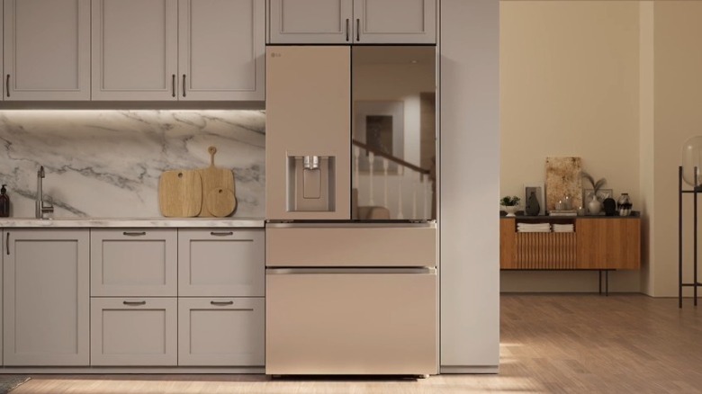 LG four-door fridge in a sleek modern kitchen with a marble backsplash.