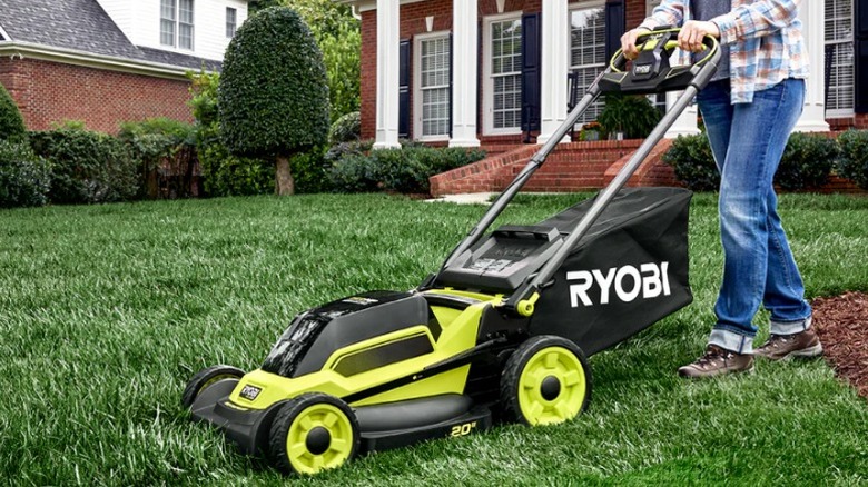 Person mowing grass with 18V HP 20-inch Self-Propelled Walk Behind Mower