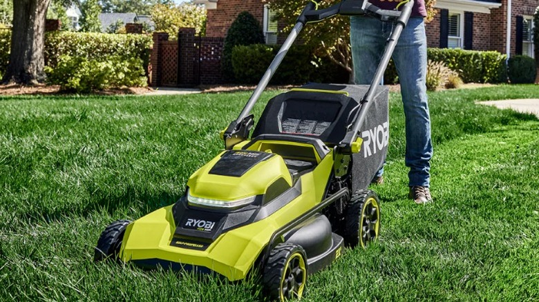 Person mowing grass with 40V HP Brushless 21-inch Self-Propelled Blade Walk Behind Mower