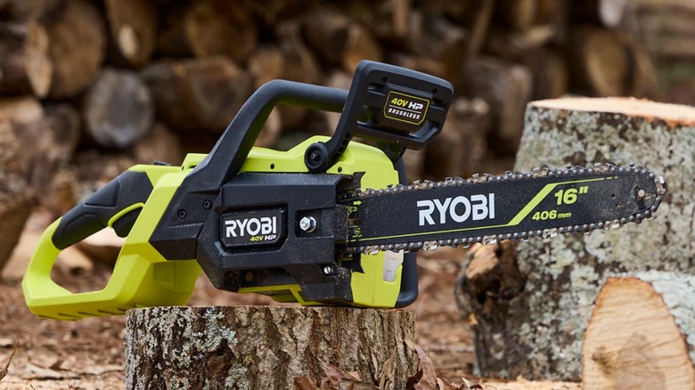 40V HP Brushless 16-inch Chainsaw sitting on stump