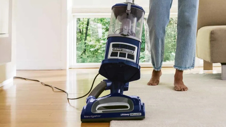 Person vacuuming floors