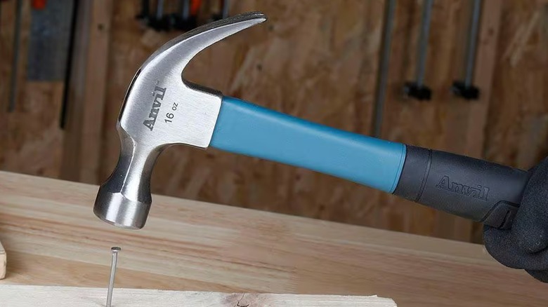 Hitting nail on wood with an Anvil claw hammer