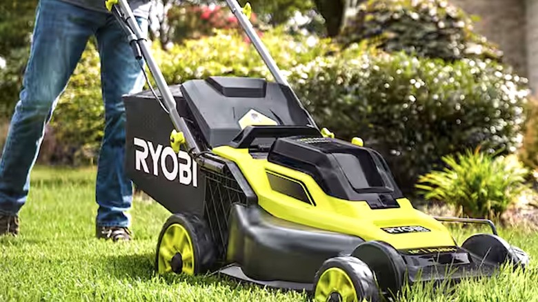Person using Ryobi lawn mower