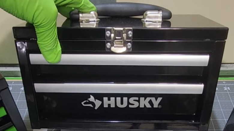 Person holding Husky 10-inch Black Metal Mini Portable Tool Box