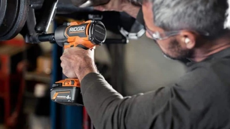 Person attaching bolt with Ridgid 18V Brushless 4-Mode ½-inch High-Torque Impact Wrench