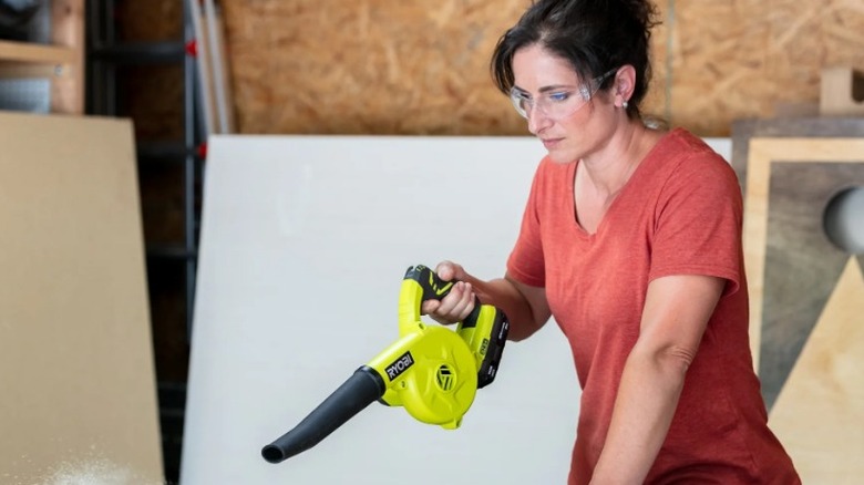 Person using Ryobi One+ Workshop Blower in a workshop