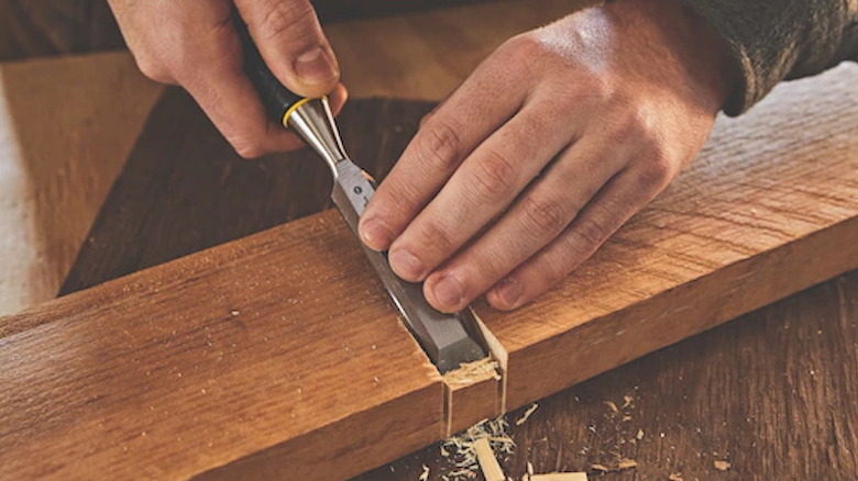 Person using Stanley wood chisel