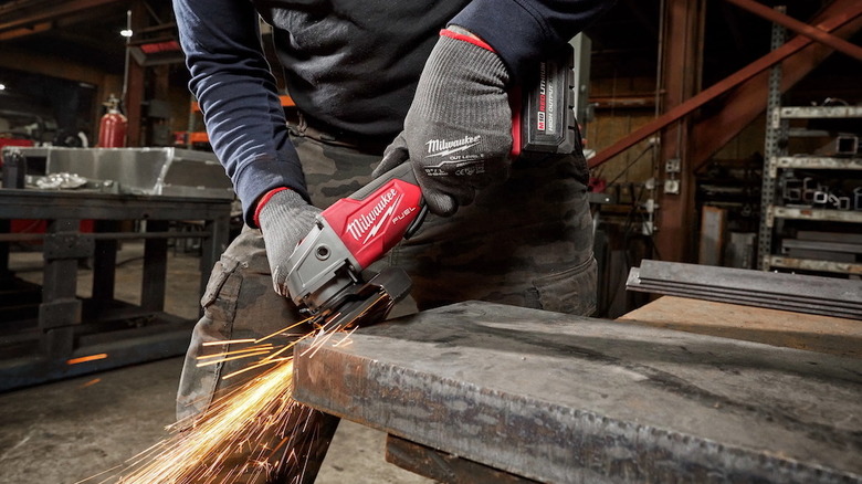 Person using a Milwaukee M18 FUEL 4.5/5-inch angle grinder