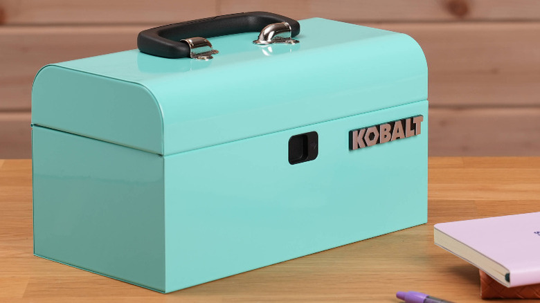 A teal metal toolbox by Lowe's Kobalt on a wooden surface.