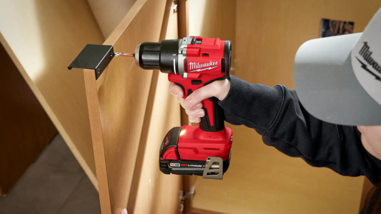 A person using Milwaukee's M18 drill/driver
