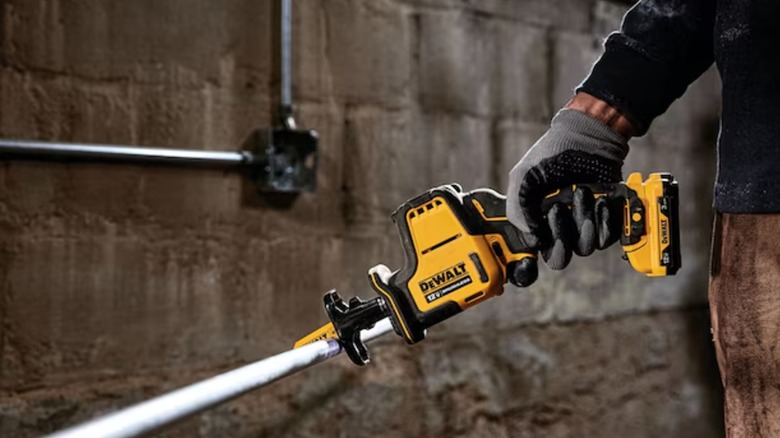 cutting a pipe with DeWalt reciprocating saw