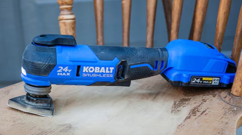 Kobalt Oscillating Multitool with sanding pad on a wooden chair