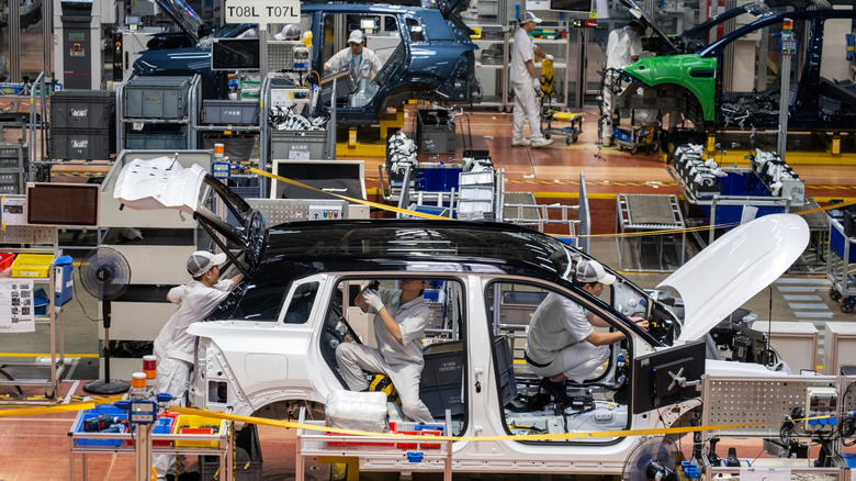 Workers assembling vehicles in a Chinese factory.