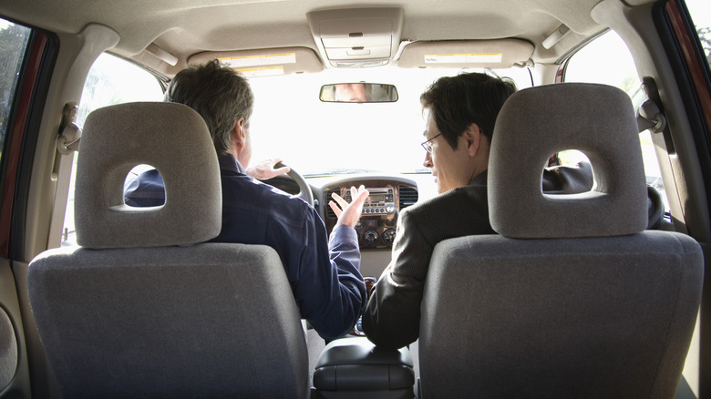 Two people seated in a car