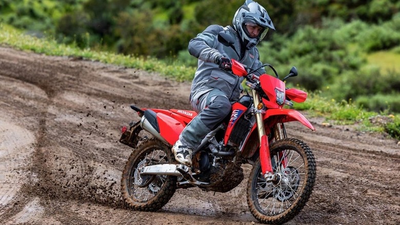 The Honda CRF450RL ripping up a muddy trail.