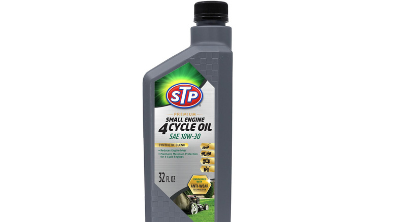 Bottle of STP 10W-30 oil on plain background