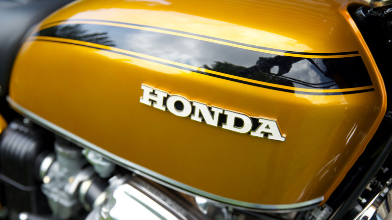 A closeup of a yellow vintage Honda CB750 bike