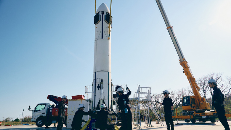 Honda's reusable rocket being held by a crane