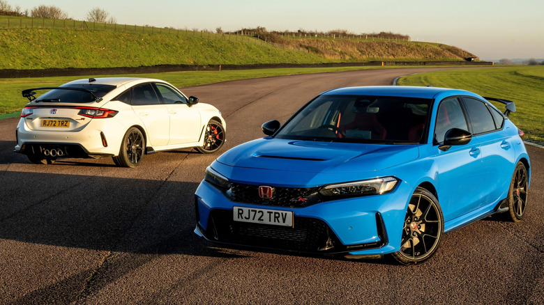 Two Honda Civic hatchbacks parked on a track