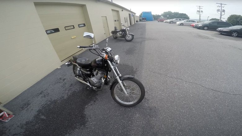 A black Honda Rebel 250 outside of a warehouse, front 3/4 view
