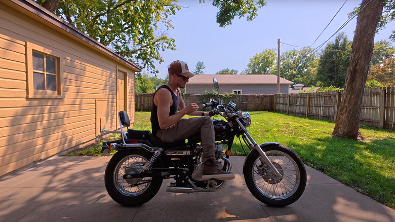 A 6-foot-tall rider sitting on a Honda Rebel 250 looks uncomfortable.