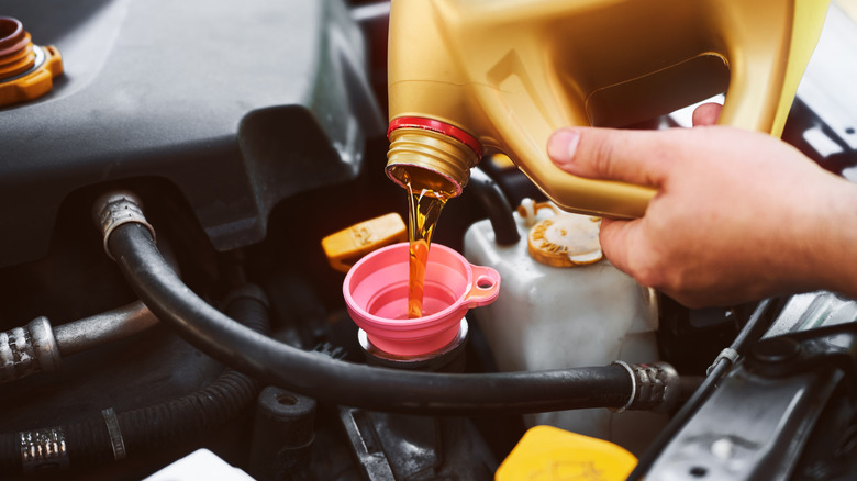 Vehicle oil change with yellow canister tool