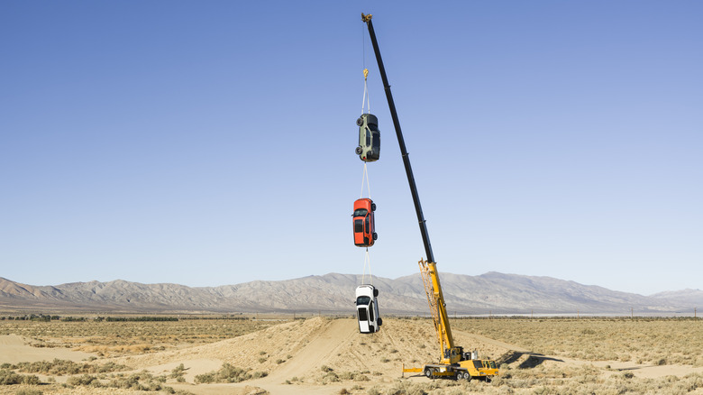 Three 2026 Honda Passports hanging from a crane.