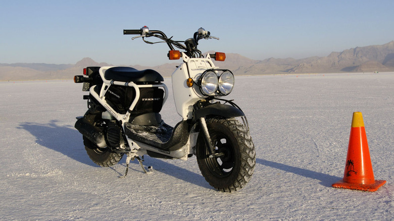 White Honda Ruckus parked at a salt flat