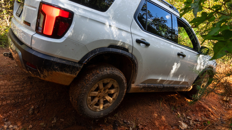 2026 Honda Passport TrailSport descending down a rough, rugged, red clay trail