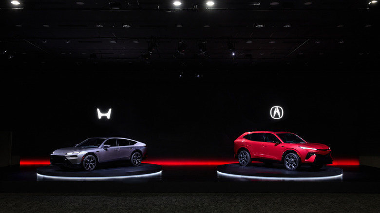 Honda Sedan Prototype (left) and Acura SUV Prototype (right) on stage, front-left and front-right 3/4 views