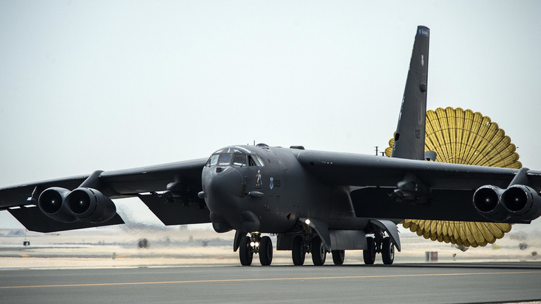 A B-52 landing on a runway.