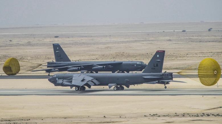 Two B-52 bombers landing on runways.