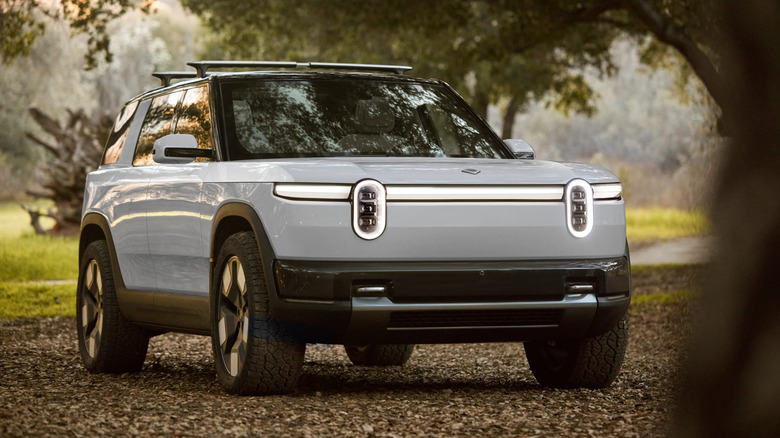 Rivian R2 under the shade of a tree