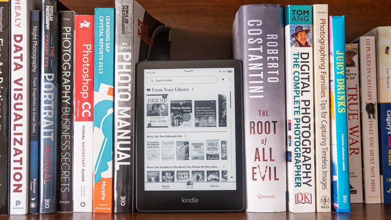 Kindle reader on bookshelf