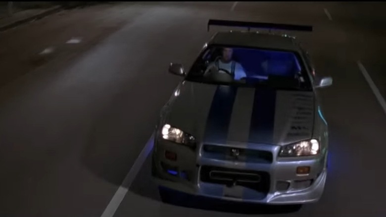 1999 Nissan Skyline R34 driving along highway, front top-down view