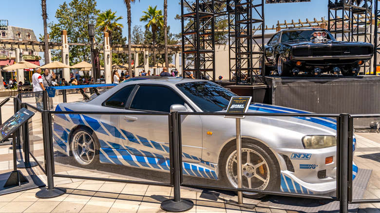 2 Fast 2 Furious Nissan Skyline behind glass barricade at exhibition event, right-side view