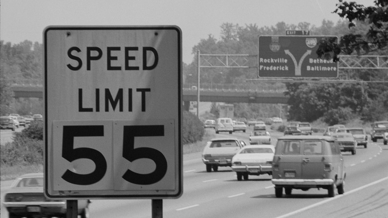 Black and white 55 speed limit sign on highway