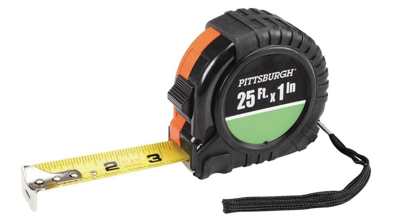 Orange and black Pittsburgh tape measurer on white background