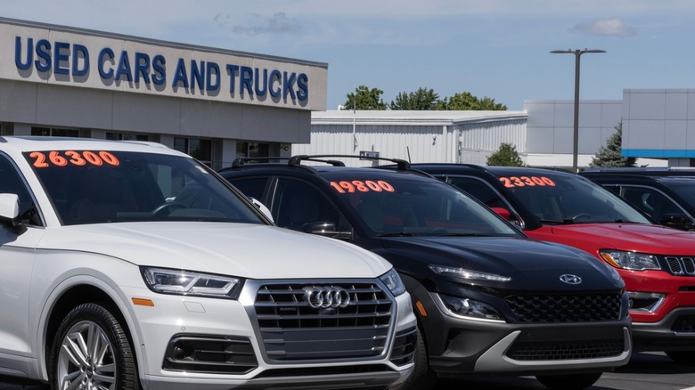 Cars with prices displayed on a used car lot