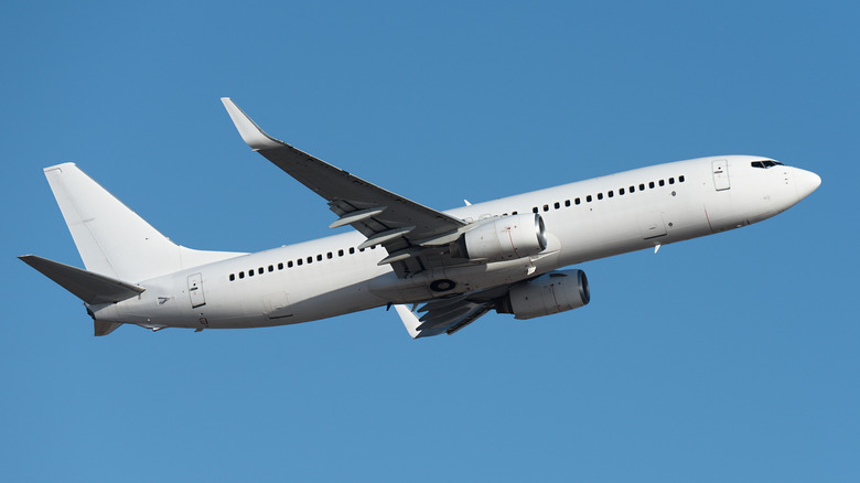 Aircraft flying on sky background