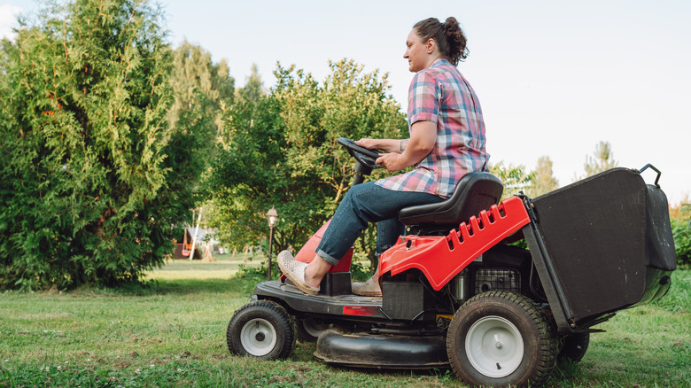 Woman on riding lawn mower