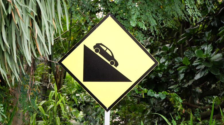 Road sign indicating a slope ahead